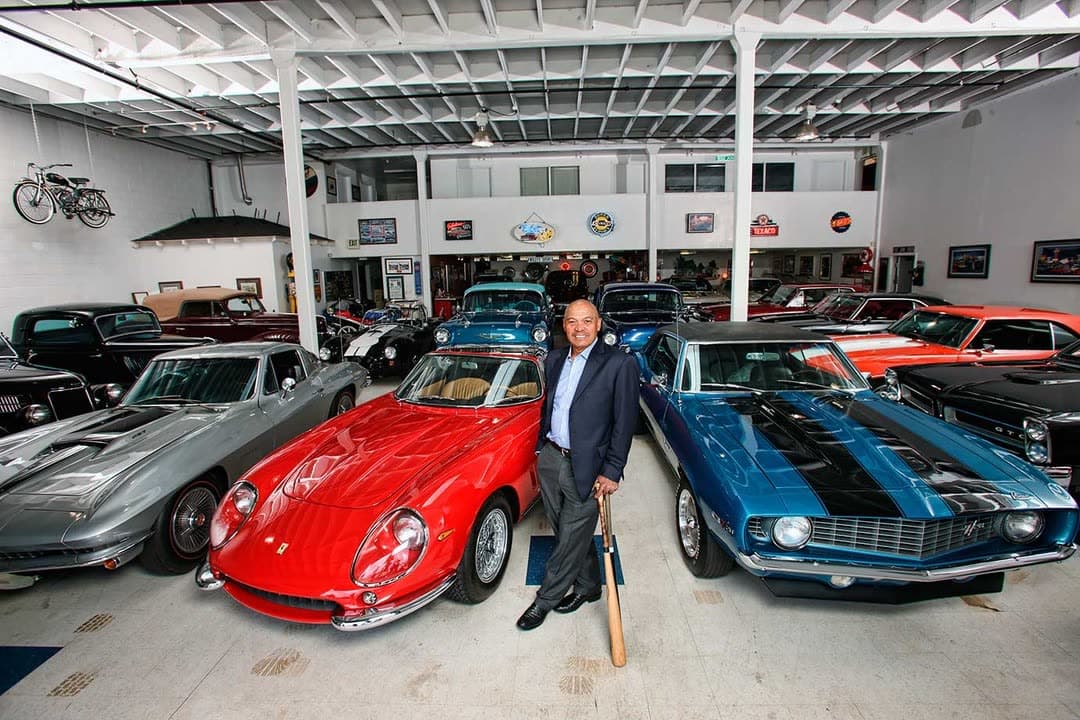 Reggie Jackson standing among the cars of his collection inside Reggie's Garage
